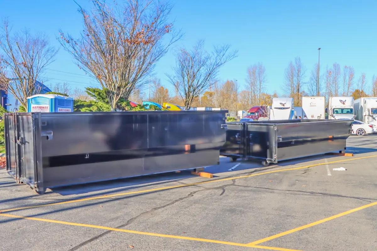 Professional dumpster rental service with roll-off container on residential driveway in Luling